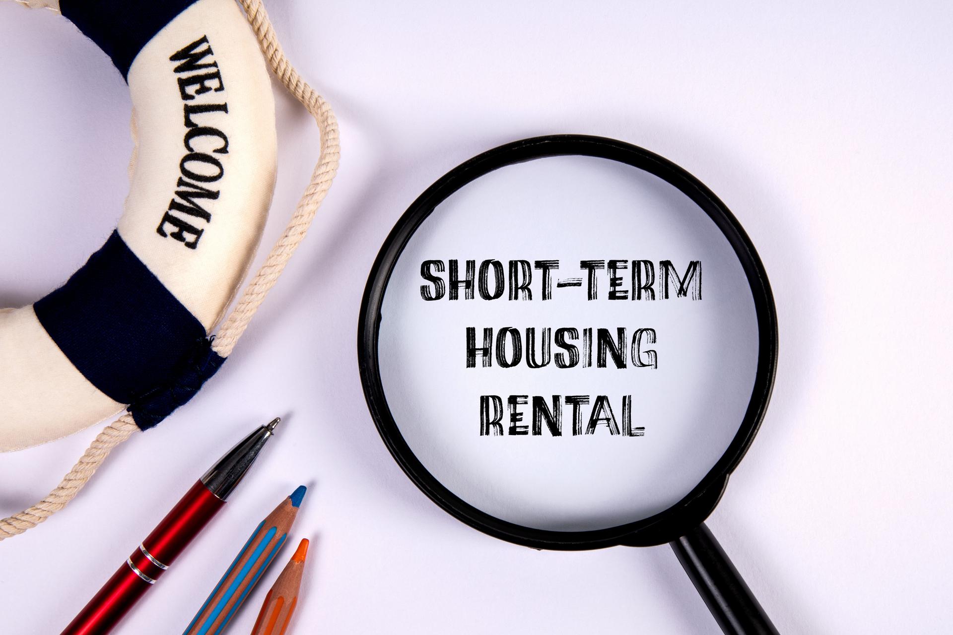 Short-Term Housing Rental. Magnifying glass with text on a white background